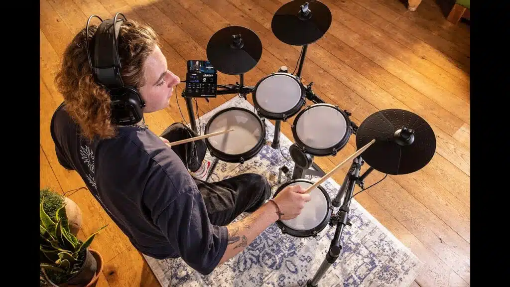 a man playing a drum set Alesis Nitro Max Kit leguidedesbatteurs.com