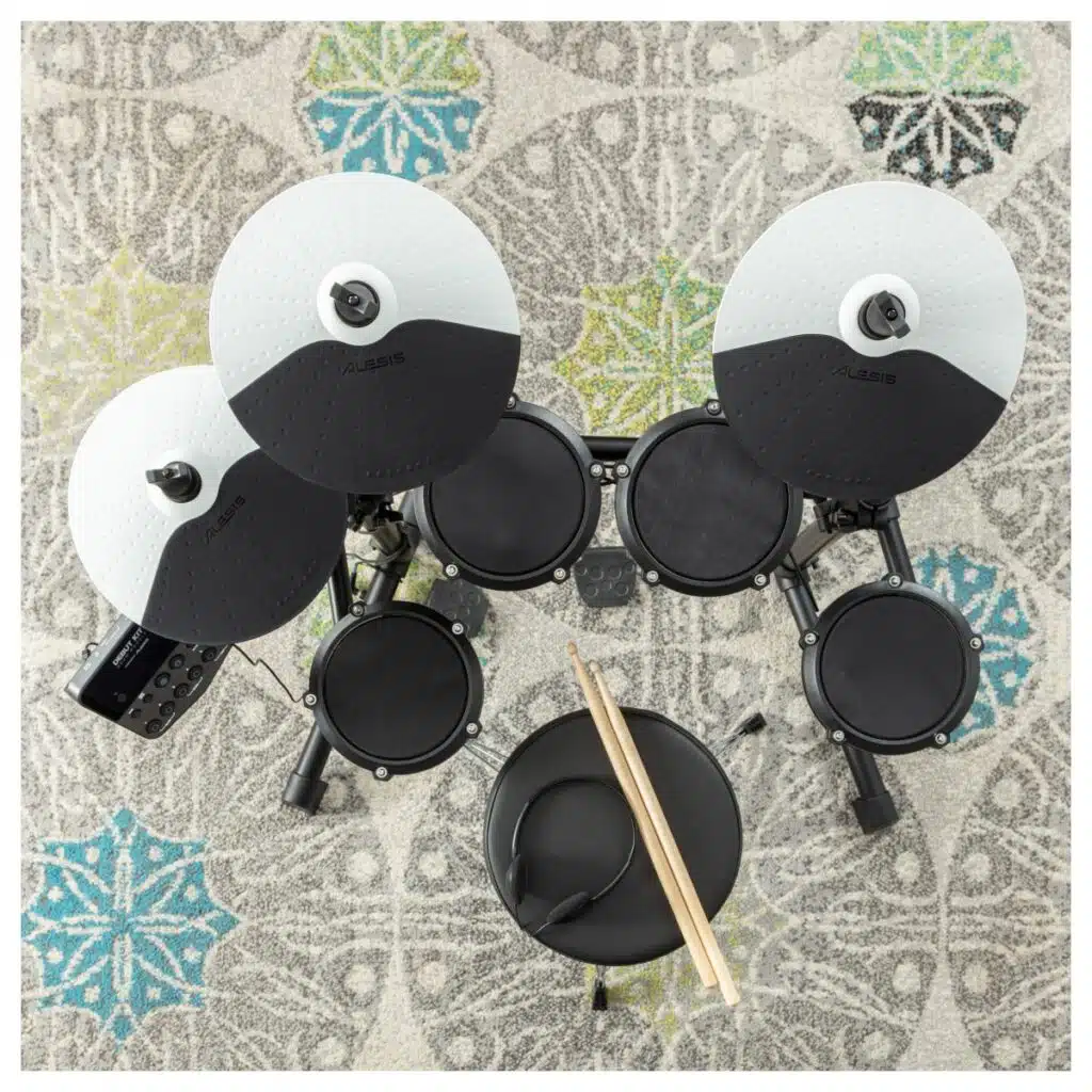 a drum set on a rug
Alesis Debut Kit