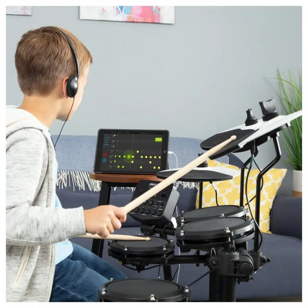 a boy playing a drum set
Alesis Debut Kit