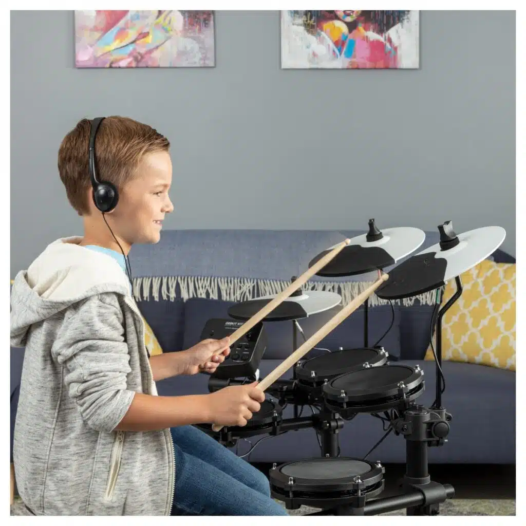 a boy playing a drum set
Alesis Debut Kit