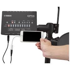 a hand holding a phone to a device