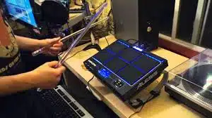 a person holding sticks in their hands
Alesis Sample Pad Pro