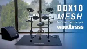 a drum set in a room Woodbrass DDX10-MESH leguidedesbatteurs.com