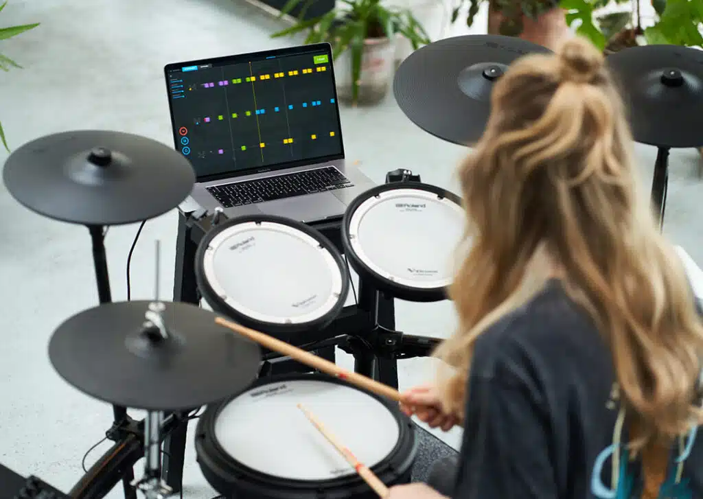 a woman playing drums with a laptop
Roland TD-17KVX2