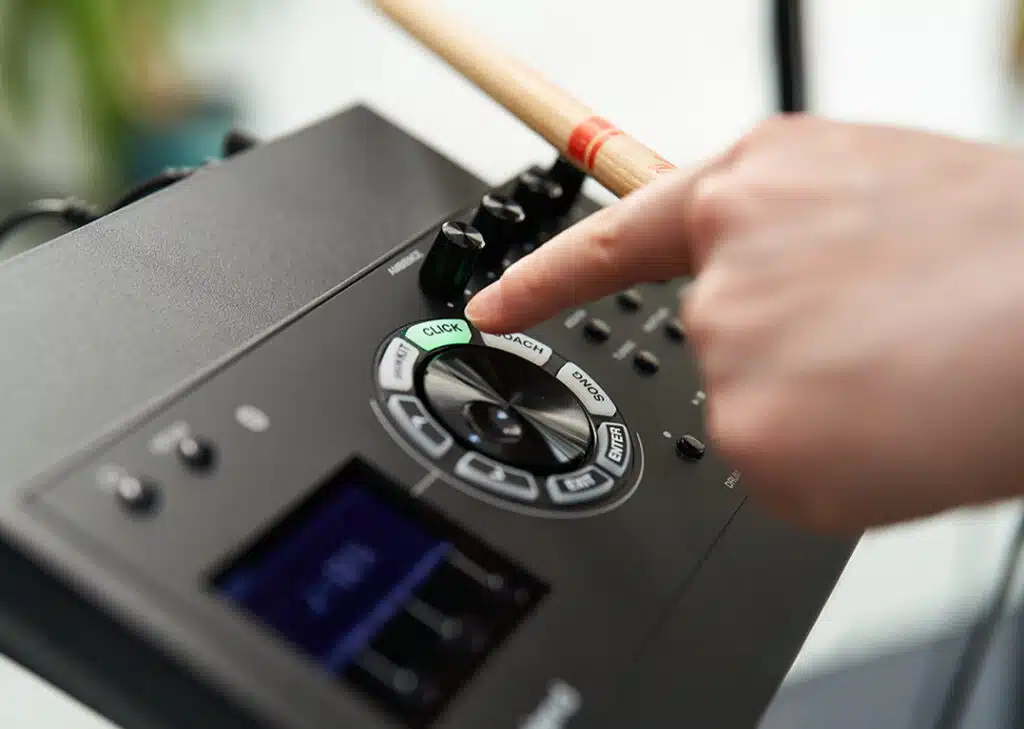 a person's hand pressing a drum set button
Roland TD-17KVX2