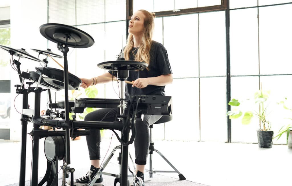 a woman playing a drum set
Roland TD-17KVX2