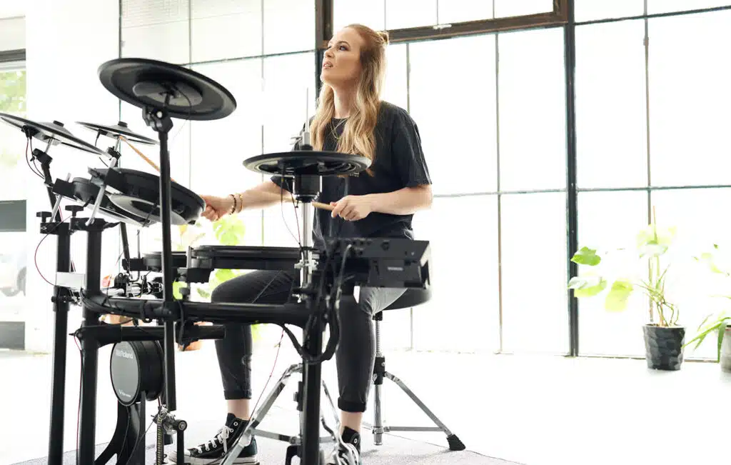 a woman playing a drum set
Roland TD-17KVX2