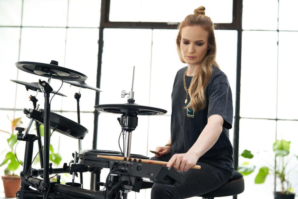 a woman playing a drum set
Roland TD-17KVX2
