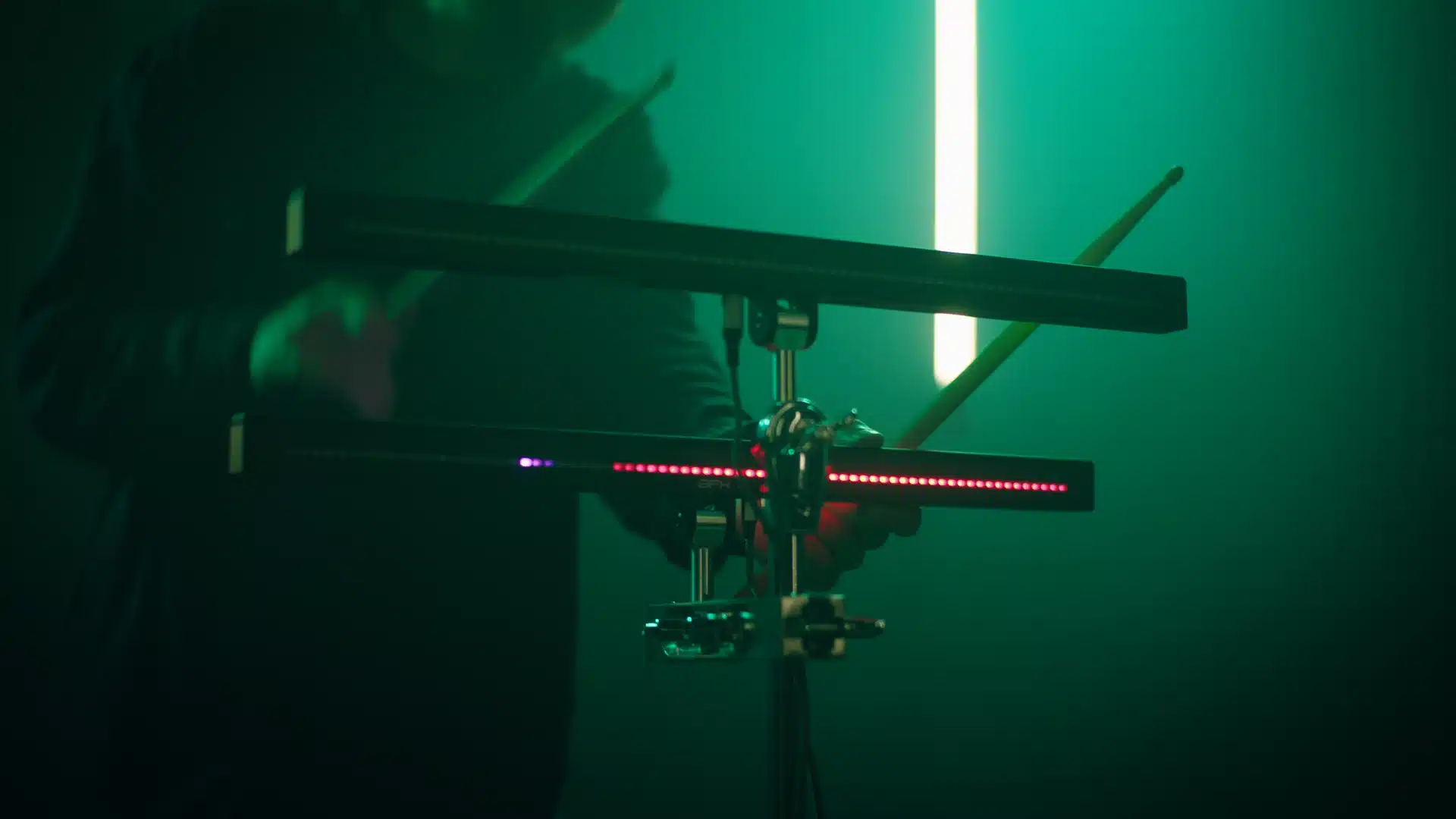 Batteur avec des baguettes, éclairage vert AFK Drumbeam