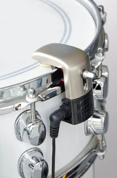 Trigger 2box TrigIt monté sur le cercle d'une caisse claire blanche, câble jack coudé branché